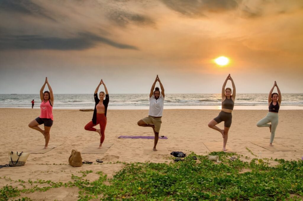 Small group yoga class on the beach near Bentota, Sri Lanka
